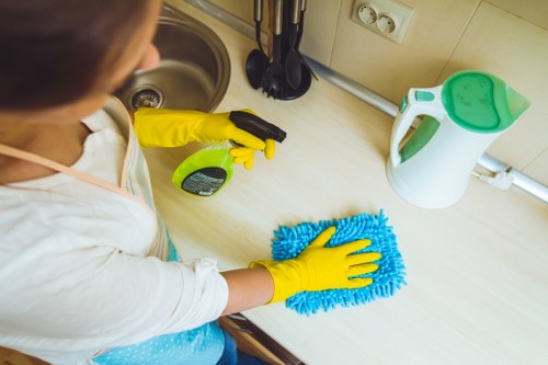 Technician operating carpet cleaning equipment with attention to hazards