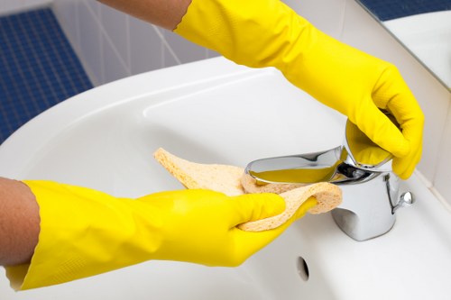 Local technician removing stains from a sofa in Acton